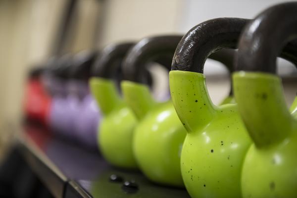 Row of green, purple, and red kettlebells