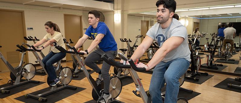 Three students on stationary bikes