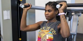 Woman using crest press exercise equipment