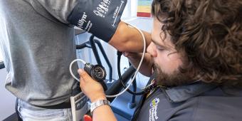 Researcher measuring blood pressure