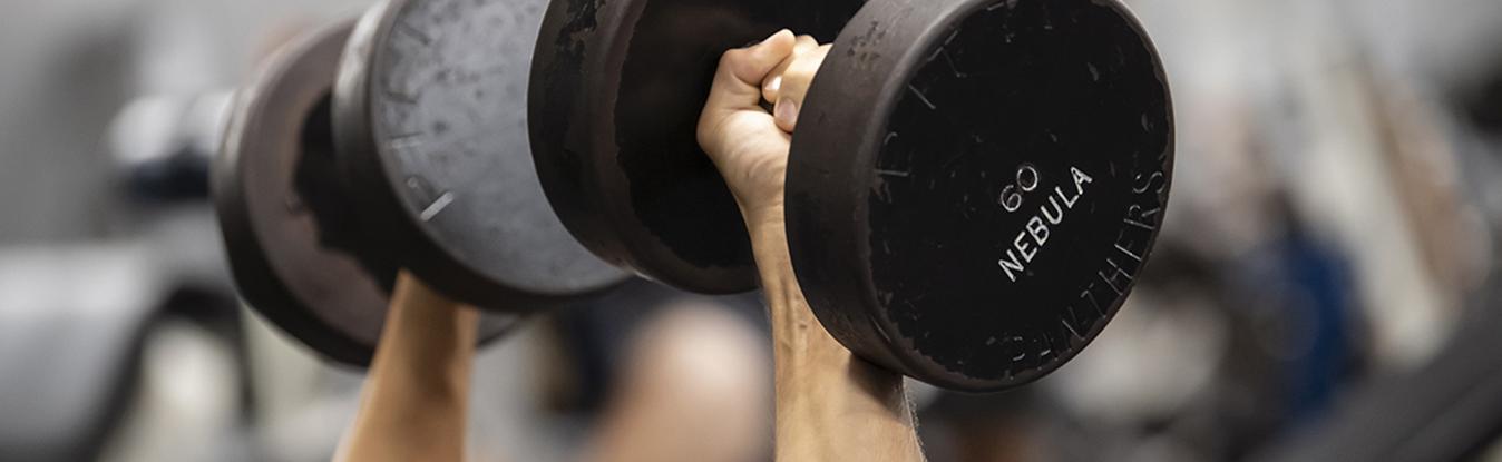 Close up of a person lifting dumbbells